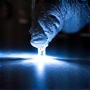 Detailer inspecting paintwork with a swirl finder light.