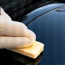 Applicator pad applying a ceramic coating to a car hood.